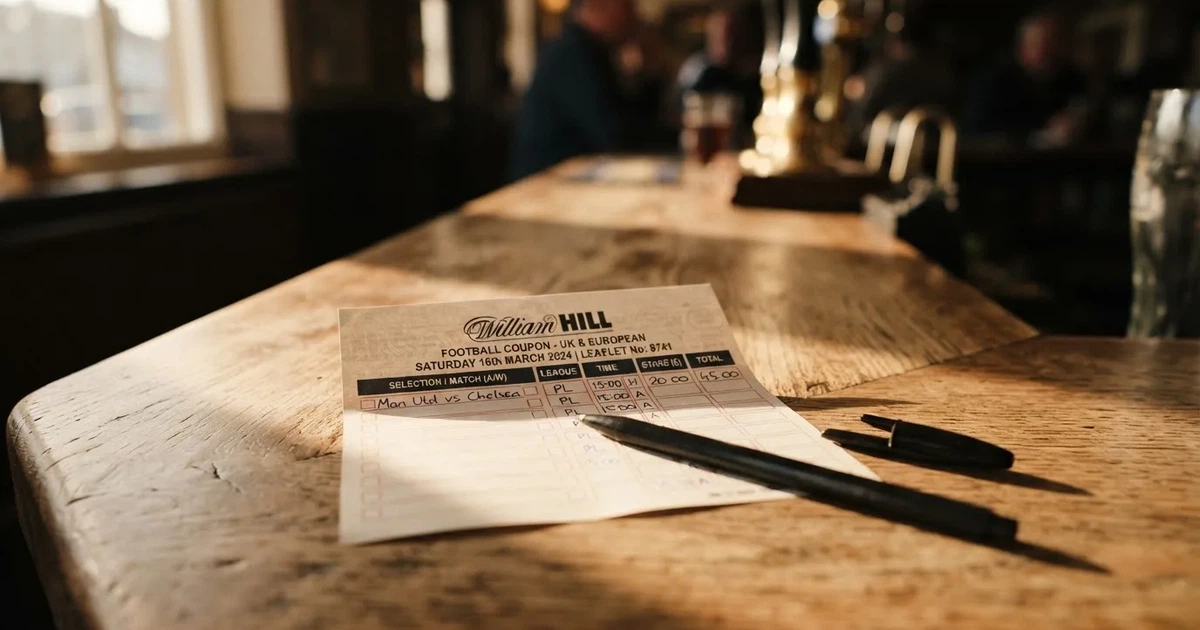 A blank paper betting slip beside a pen on a wooden counter