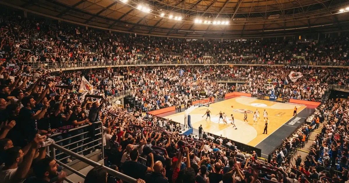 A packed sports hall under floodlights photographed from a long way off